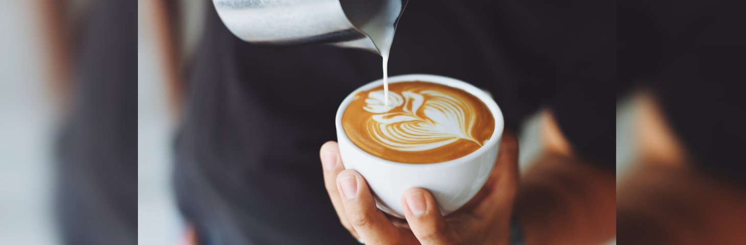 A barista making a latte.