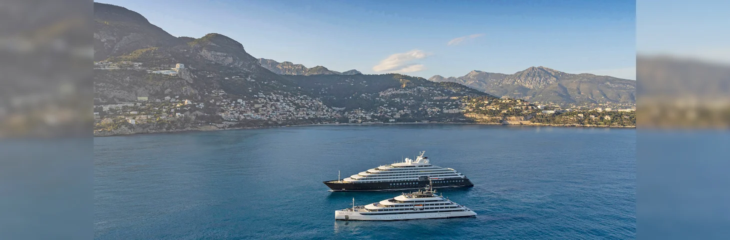 Scenic Eclipse and Emerald Azzurra sailing out of Monte Carlo, Monaco.