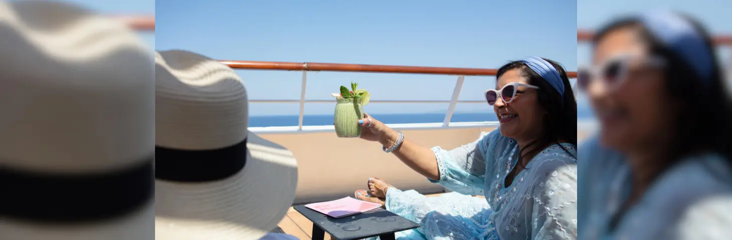 Image of a woman enjoying her drink on a sun deck aboard a ship