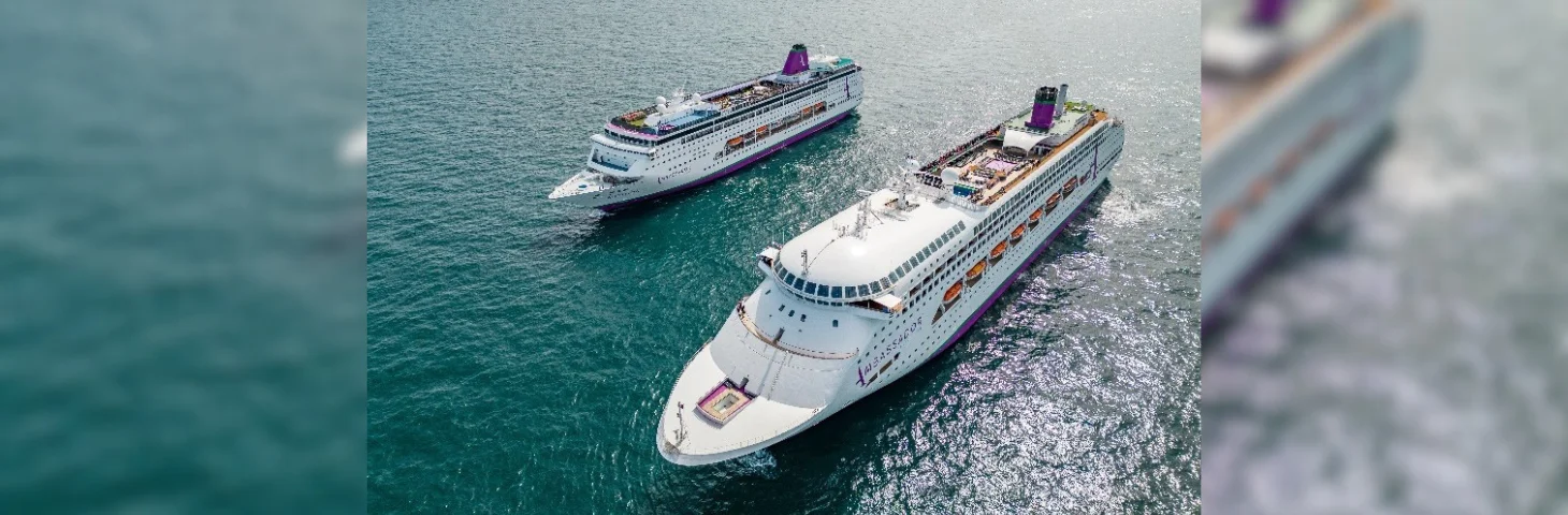 Aerial shot of Ambassador Cruise Line's fleet, comprised of Ambition and Ambience, at sea.